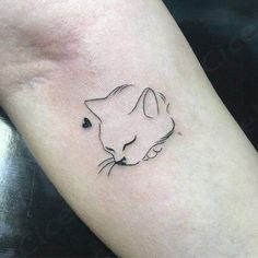 a small cat tattoo on the arm