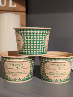 three ice cream containers sitting on top of a counter