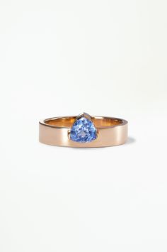 a gold ring with a blue stone in the center