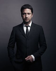 a man in a suit and tie posing for the camera