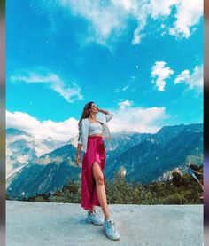 a woman standing on top of a mountain