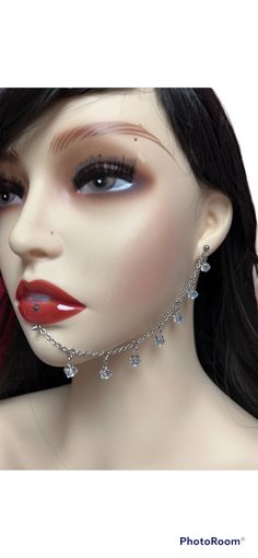 a mannequin head wearing a necklace and earrings