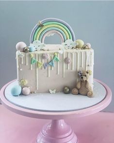 a cake with white frosting and rainbow decorations