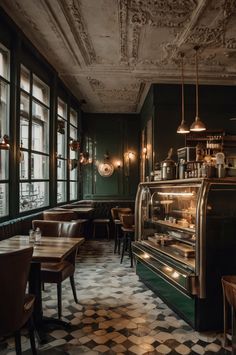 an empty restaurant with green walls and checkered flooring on the floor is seen in this image