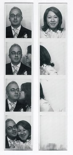 an old black and white photo shows four people in different poses, one is kissing the other's head