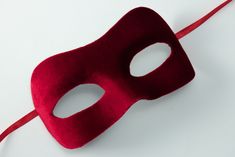 Red masquerade mask decorated with red velvet fabric and satin ribbons. Masquerade masks made by Maskaku are a product of love for beauty and handicrafts.  All products are unique and entirely hand-made. Masks can cover your face but you are still guaranteed to stand out wearing one of them. They are ideally suited for a masked ball, costume party or a wedding gift. Many designs come in pairs both for him and for her in similar colors but unique shapes.  I'm sure you will find the one that suits Red Masquerade Mask For Mardi Gras Party, Red Party Masks For Mardi Gras, Elegant Red Masquerade Mask For Party, Red Eye Mask Masquerade For Costume Party, Red Venetian Masquerade Mask For Party, Red Eye Mask For Costume Party, Red Eye Masks For Party, Venetian Red Masquerade Mask For Party, Red Eye Mask For Party