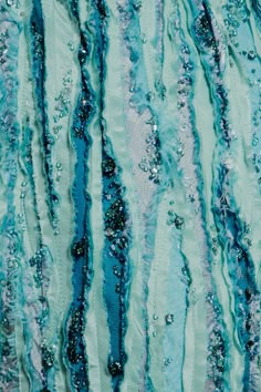 an abstract painting with blue, green and white stripes on it's surface is featured in this image