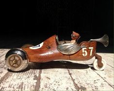 an old fashioned wooden toy car with numbers on the side