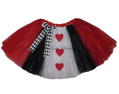 a red, white and black tutu skirt with hearts on the bottom is shown