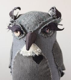 an owl made out of old jeans with lace on it's eyes and nose