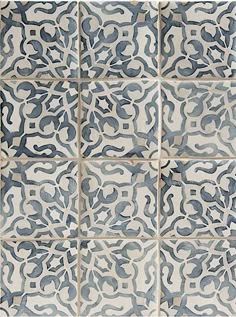 blue and white tiles are arranged on the wall in an intricate pattern, with different shapes