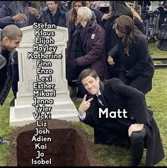 a man kneeling in front of a grave with the names of people around him on it