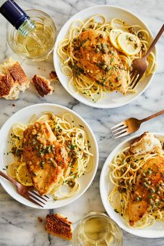 three plates of pasta with chicken, parmesan and olives on the side