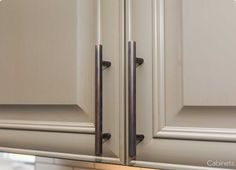 an image of kitchen cabinets with handles on them