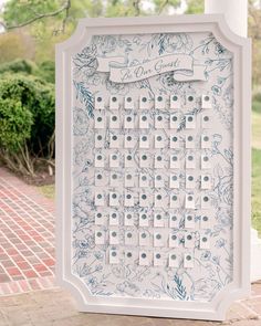 a blue and white board game sitting on top of a brick walkway