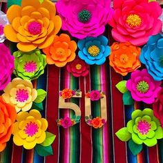 colorful paper flowers are arranged in the shape of numbers