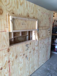 the inside of a building being constructed with plywood and wood planks on the walls