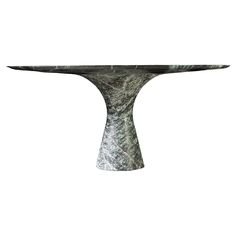 an artistically designed table with marbled design on it's base, against a white background