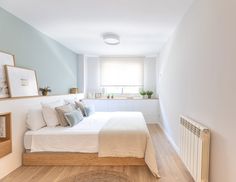 a bed sitting in the middle of a bedroom on top of a hard wood floor