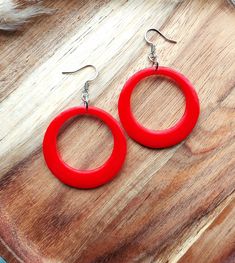 These fabulous drop hoop earrings are inspired by my love of all things mid-century and will be perfect for the upcoming holiday season. The circle hoops are made from a gorgeous bright red resin, and they are hung from delicate stainless steel ear wires. The hoops measure 38mm in diameter and the total earring drop is 60mm. You can find more of my 50s and 60s inspired drop hoops available here: www.etsy.com/uk/shop/RosieMays?section_id=25135598 Please get in touch if you'd like these in a diffe Drop Hoop Earrings, I Am Statements, Red Circle, Resin Earrings, Pin Up Style, Jewelry Earrings Hoops, Up Styles, Bright Red, Ear Wires