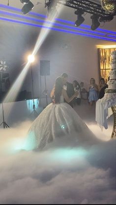 a bride and groom are kissing in the clouds at their wedding reception, surrounded by lights