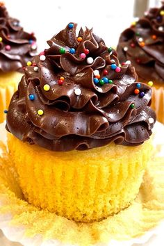 two cupcakes with chocolate frosting and sprinkles on top are shown