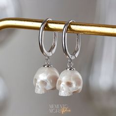 💀CUSTOM made to order Every single piece is hand-carved for the order. Please notice that every skull piece is unique and may have a slightly different shape 💀PEARLS: Genuine White Freshwater Pearls Ranging in size, from 10mm to 12mm. 💀Earrings Metal: 925 Sterling Silver 💀 𝕿𝖍𝖆𝖓𝖐 𝖞𝖔𝖚 𝖋𝖔𝖗 𝖘𝖍𝖔𝖕𝖕𝖎𝖓𝖌 𝖜𝖎𝖙𝖍 𝕸𝖊𝖒𝖊𝖓𝖙𝖔 𝕸𝖔𝖗𝖎 𝕻𝖊𝖆𝖗𝖑𝖘! White Skull-shaped Sterling Silver Jewelry, White Sterling Silver Skull Jewelry, Silver Skull Earrings For Pierced Ears, Silver Skull Shaped Single Earring, Silver Skull Earrings With Ear Wire, Sterling Silver Skull Earrings For Gift, White Sterling Silver Drop Cartilage Earrings, White Sterling Silver Cartilage Earrings, Sterling Silver White Cartilage Earrings With Ear Wire