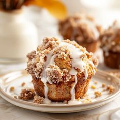 a muffin on a plate with icing drizzled over it's top