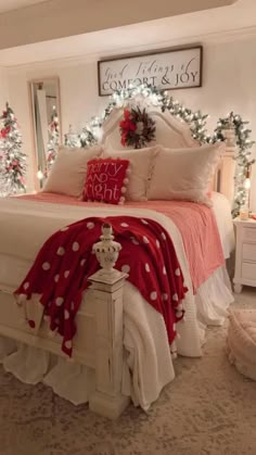 a bedroom decorated for christmas with red and white decor