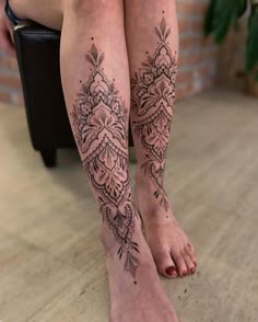 a woman's legs with tattoos on them