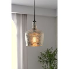 Cast a warm and welcoming glow in the foyer or bring a bit of brightness to your kitchen island with this one-light large glass pendant, which is compatible with sloped ceilings. Suspended from a black cable and secured with a black socket, its downward-facing glass shade showcases hammered glass for fun flair and accommodates one bulb of up to 60 W (not included). Assembly and installation are required for this hardwired luminary. Trent Austin Design® Finish: Silver | Trent Austin Design® Kettn Oil Rubbed Bronze Pendant Light Kitchen, Large Pendant Lights Over Kitchen Island, Lights Above Kitchen Island, Mercury Glass Pendant Light, Oil Rubbed Bronze Pendant Light, Light Over Sink, Large Glass Pendant, Lights Over Kitchen Island, Seeded Glass Pendant