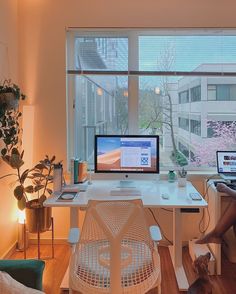 a person sitting at a desk with two computers