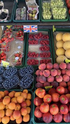 fruits and vegetables are displayed in bins for sale