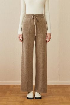 Cozy Elegance: Warm Wool Pants for Stylish Comfort Embrace the cooler seasons with these essential wool lounge pants, perfect for both office and leisure. Crafted for the fashion-conscious, they offer slight stretch for comfort and are ideal for the fluctuating temperatures of spring, fall, and winter. The quality wool fabric ensures warmth and a unique style. The solid color and simple design make them versatile for any top, from business casual to everyday wear. The delicate knitting adds soph Elegant And Simple Outfits, Warm Winter Pants, Fall Pants 2024, Wool Pants Women, Knitted Pants Outfit, Fashion Rebranding, Wool Pants Outfit, Outfits With Ankle Boots, Lounge Wear Winter