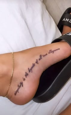 a woman's foot with an inscription on it that reads, nothing is the light of all things