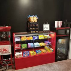 a display case filled with lots of different types of snacks and drinks next to a vending machine