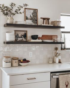 the shelves above the kitchen sink are filled with dishes and utensils for cooking