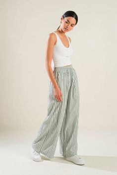 A classic striped woven pant featuring elastic waist with front tie, side pockets and wide leg silhouette. Pair with the Katalina Top. 100% Cotton // Hand wash cold // Made in China Uni Outfit, Striped Linen Pants, Kimono Sweater, Striped Wide Leg Pants, Stripe Outfits, Wishful Thinking, Summer 24, Baggy Pants, Peasant Top