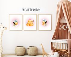 a baby's room with three framed pictures on the wall and a giraffe toy next to it