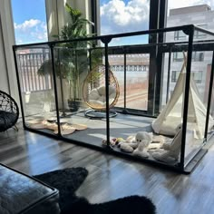 a living room filled with furniture next to a large glass window overlooking the cityscape