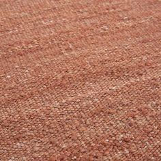 an area rug with brown and white dots on the ground, closeup view from above