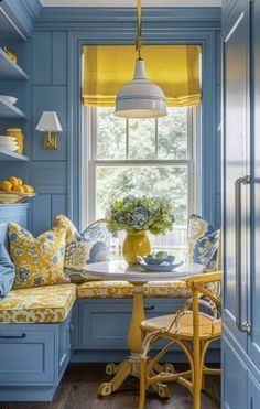 a kitchen with blue walls and yellow curtains on the window sill is shown in this image