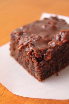 a piece of brownie sitting on top of a white napkin