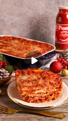 two plates with lasagna casserole on them next to a can of tomato sauce