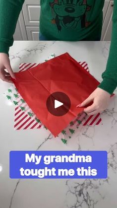 someone is making a red paper bag with the words, my grandma taught me this