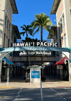 an entrance to a building with palm trees in the background