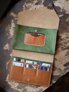 Crafted from premium full-grain leather, this personalized wallet purse is the perfect gift for Dad or anyone who values quality and style. With spacious compartments for cards, cash, and even a phone, this leather clutch is as functional as it is stylish. Add a custom name or initials for a personal touch that makes it uniquely yours. Built to last, this versatile pouch is perfect for everyday use or special occasions.  DETAILS: -Full grain vegetable leather  -7 compartments for for up to 14 ca Green Leather Pouch For Gift, Green Leather Pouch As Gift, Trifold Leather Bag As Gift, Leather Pouch Wallet For Gift, Leather Wallet Pouch As Gift, Green Leather Pouch Wallet, Rectangular Smooth Grain Wallet As Gift, Leather Bifold Pouch With Card Slots, Leather Envelope Wallet With Interior Card Slots