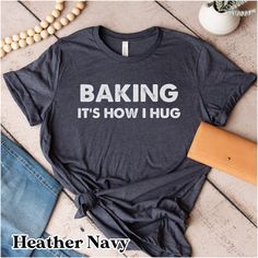 "Baking it's how I hug shirt - perfect gift for a cookie lover, baker, or chef Size of text and image will vary depending on the size of the shirt. If you would like something different or would like specific information, please feel free to message me! Sizing: Unisex. All measurements are taken while the shirts are lying flat. Width is measured across the chest (under arm to underarm). Length is measured from shoulder to the bottom of the shirt. We recommend sizing up fora roomier fit (t-shirts are  generally true to size. Made with Bella canvas t-shirts.  Bella Canvas T-shirts Approximately: (Size up for a roomier fit- T-shirts typically fit true to size) Small: 18\" W x 28\"L Medium: 20\" W x 29\" Large: 22\"W x 30\" L XL: 24\" W x 31\" L 2XL: 26\" W x 32\" L 3XL: 28\" L x 33\" L Gildan Funny Baking Shirts, Breastfeeding Shirt, Cookie Shirt, Funny Nurse Shirts, Coffee Shirt, Chef Gifts, Gildan Sweatshirts, Coffee Shirts, Color Charts