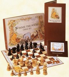 the winnie the pooh chess set is shown with its box and game pieces in it