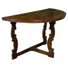 an old wooden table with carved legs and a curved top, isolated against a white background